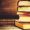 stack of books on the dark wood background. toning. selective focus on the middle book