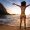 Sexy Brazilian Girl in Bikini Stands in the Beach With Open Arms and Welcomes A New Day in Rio de Janeiro With the Sugarloaf Mountain in the Background